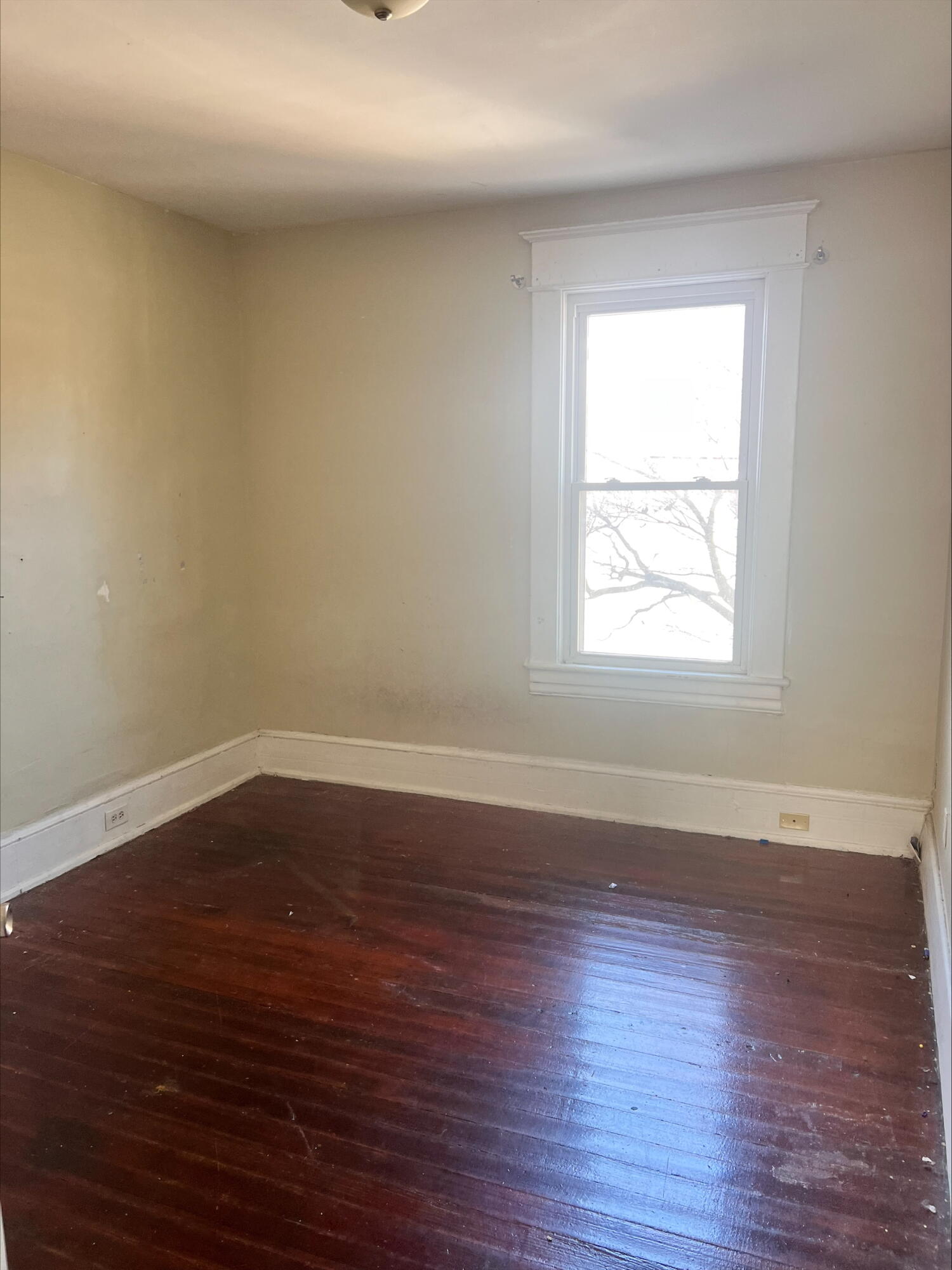 906 5th Street Southeast Roanoke, VA 24013 - Photo 6 of 11 an empty room with wooden floor and windows
