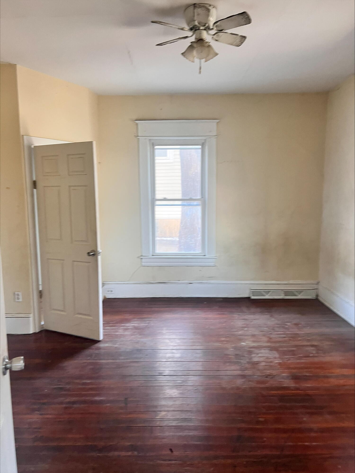 906 5th Street Southeast Roanoke, VA 24013 - Photo 9 of 11 an empty room with wooden floor chandelier fan and windows