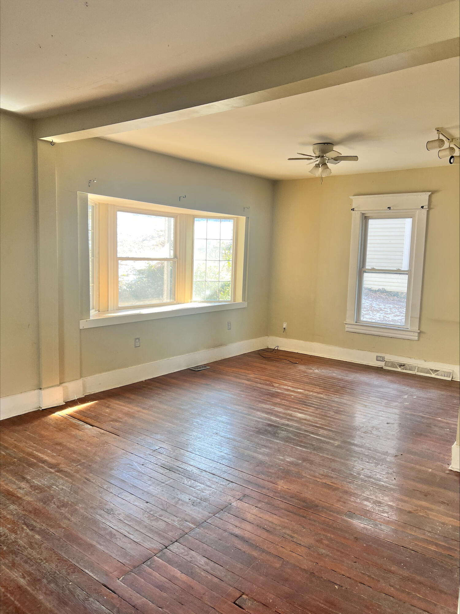 906 5th Street Southeast Roanoke, VA 24013 - Photo 10 of 11 an empty room with wooden floor and windows