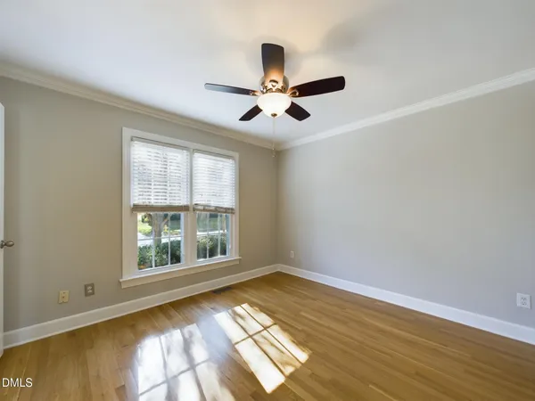 a view of a big room with wooden floor and a ceiling fan
