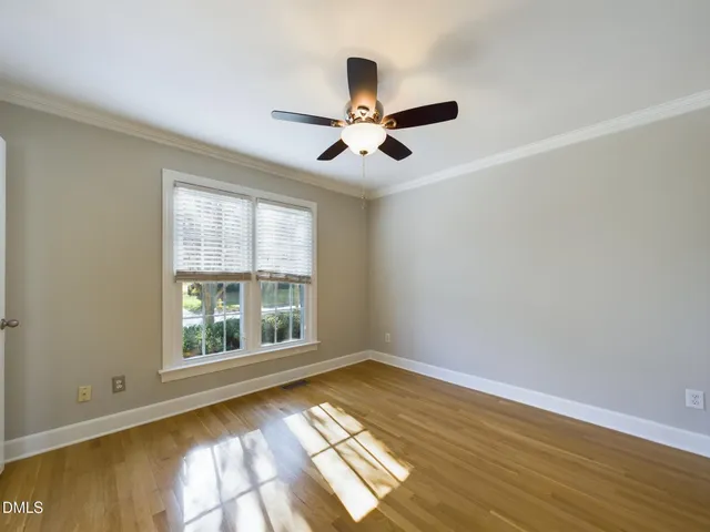a view of a big room with wooden floor and a ceiling fan