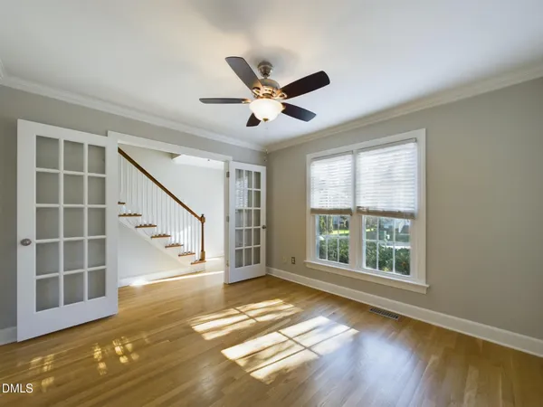 a view of empty room with wooden floor and fireplace