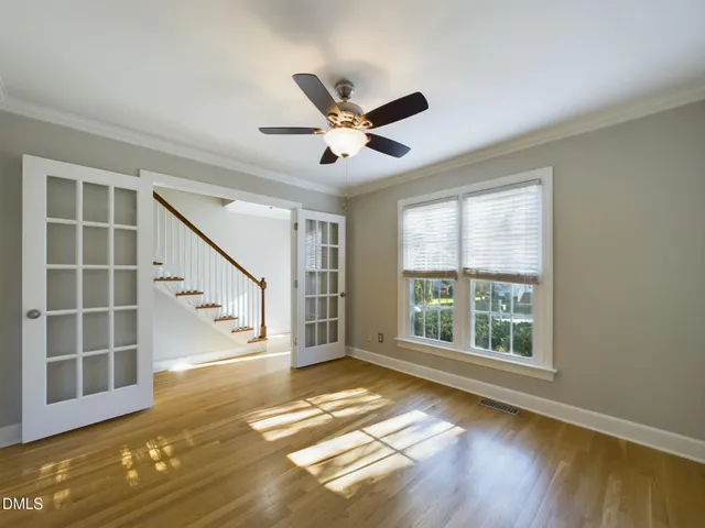 a view of empty room with wooden floor and fireplace