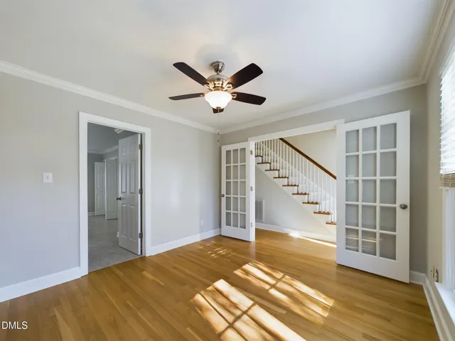 a view of an empty room with a fireplace and a window