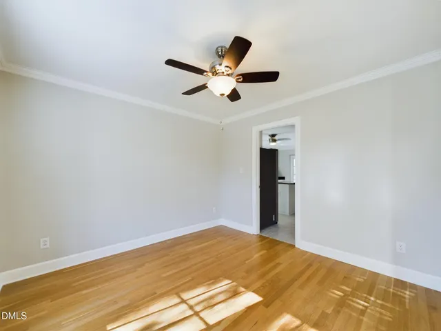 a view of empty room with wooden floor
