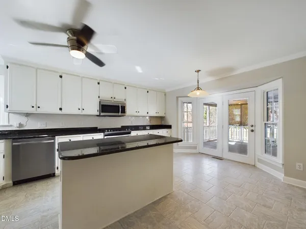 a view of a room with a large windows and chandelier