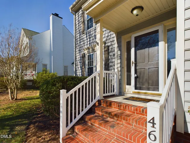a view of a house with more windows and wooden fence