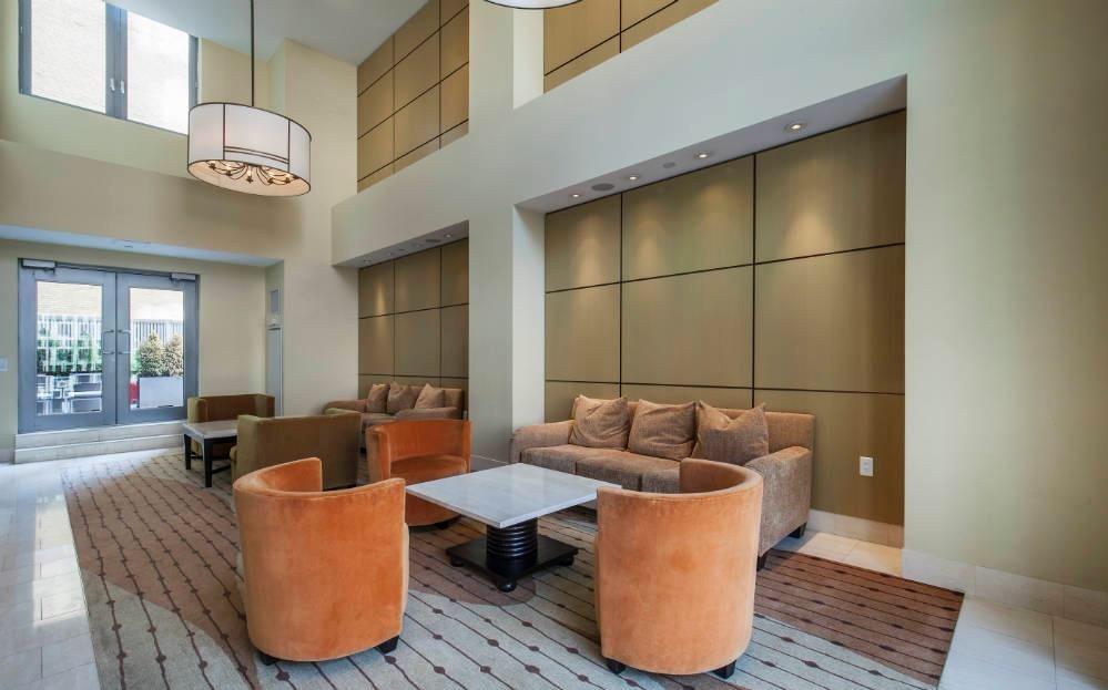 300 East 79th Street, Unit 5C Manhattan, NY 10075 - Photo 10 of 12 a living room with furniture and a window