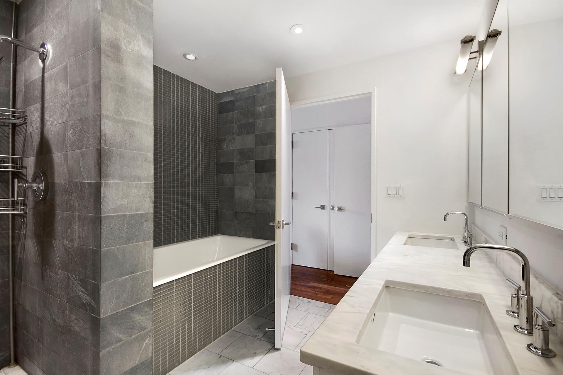 300 East 79th Street, Unit 5C Manhattan, NY 10075 - Photo 5 of 12 a bathroom with a tub sink and shower
