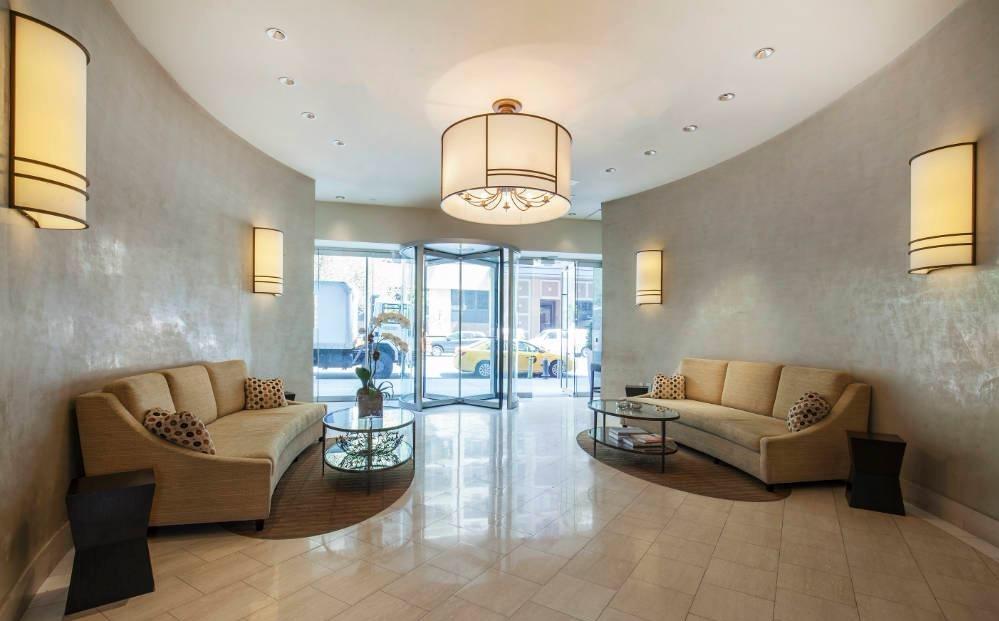 300 East 79th Street, Unit 5C Manhattan, NY 10075 - Photo 9 of 12 a living room with furniture and a large window
