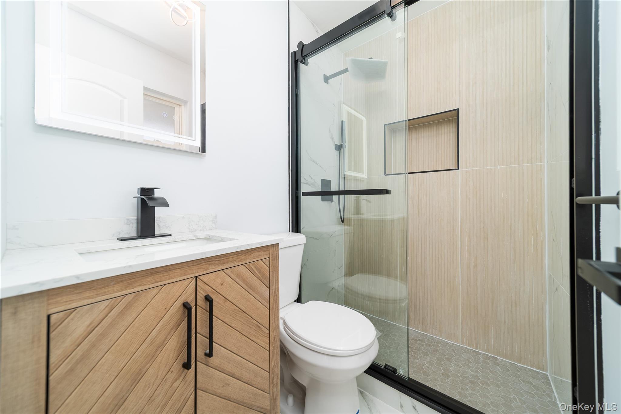 8 Spector Lane Plainview, NY 11803 - Photo 11 of 15 a bathroom with a sink a toilet and shower