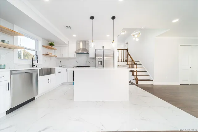 a large white kitchen with lots of white cabinets