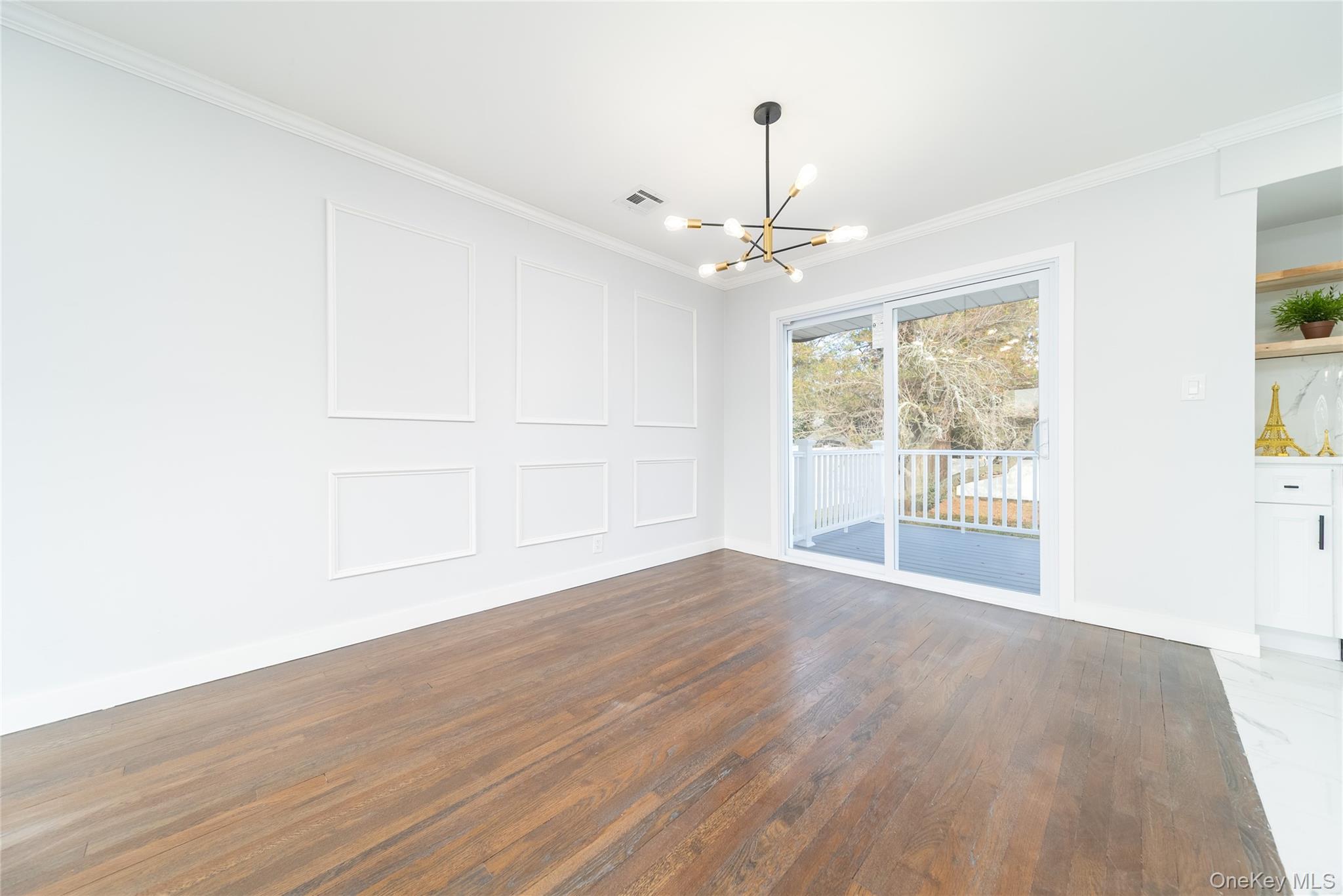 8 Spector Lane Plainview, NY 11803 - Photo 6 of 15 a view of an empty room with wooden floor and a window