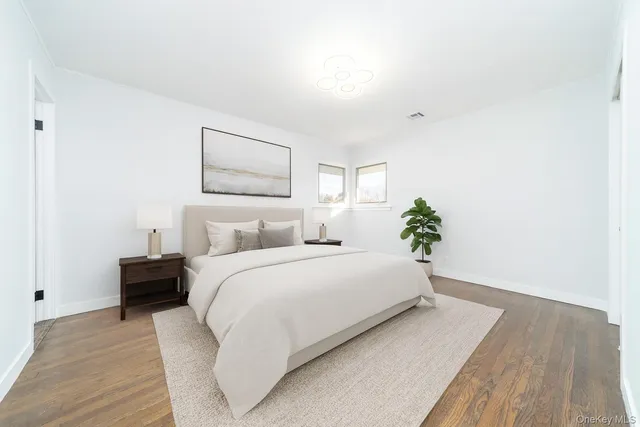 a spacious bedroom with a bed and a painting on the wall