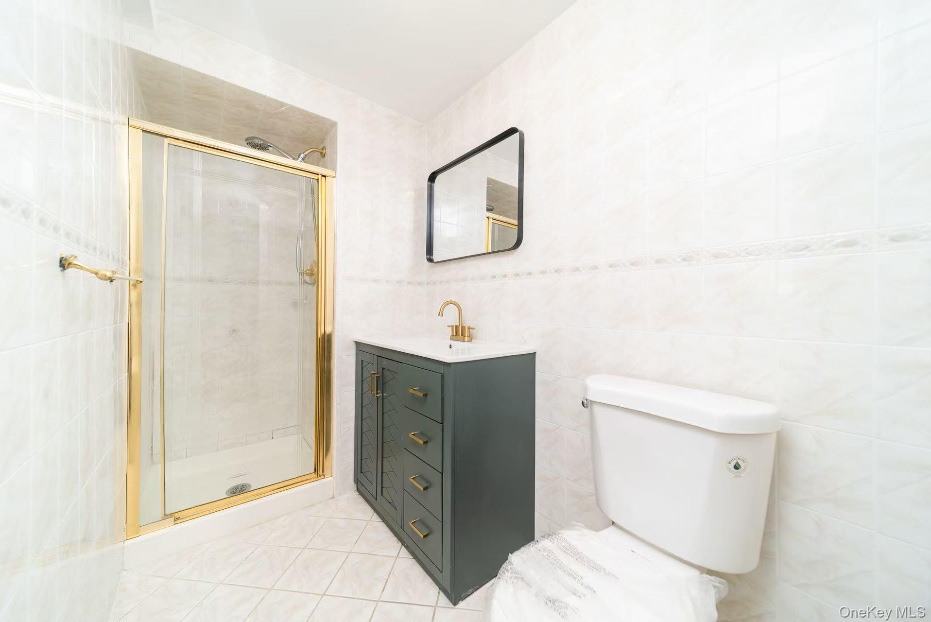 8 Spector Lane Plainview, NY 11803 - Photo 8 of 15 a bathroom with a sink a toilet and shower