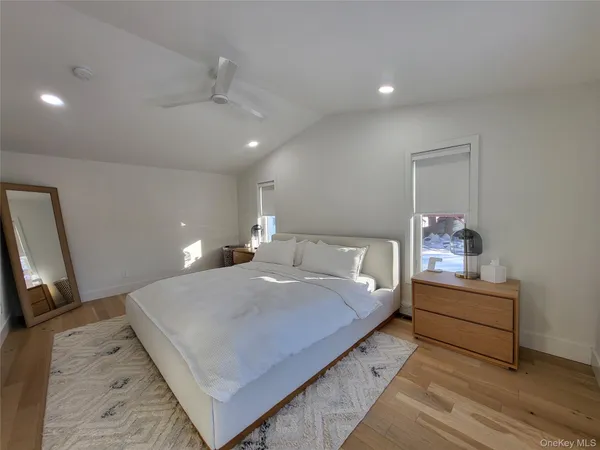 a bedroom with bed and a large mirror