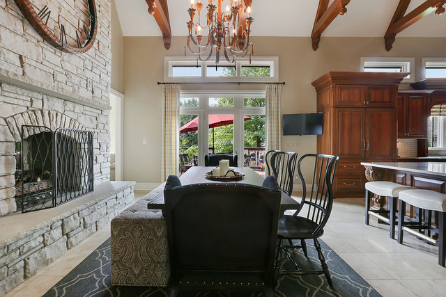 218 Shadow Ridge Court Palos Park, IL 60464 - Photo 9 of 40 a dining room with furniture a fireplace and a chandelier