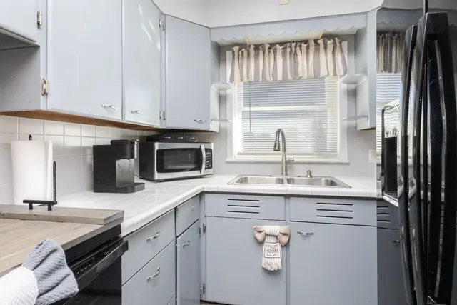 a kitchen with a sink and cabinets