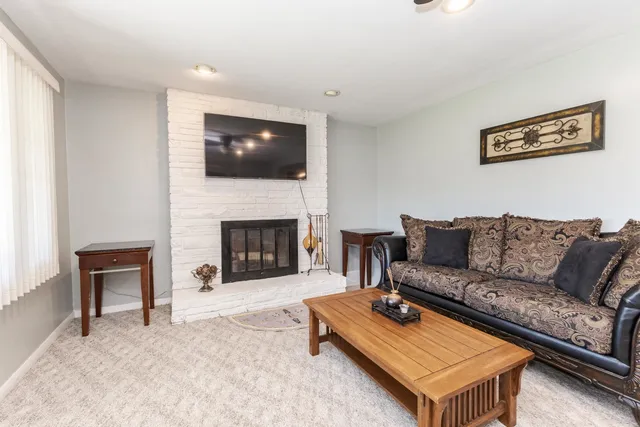 a living room with furniture and a fireplace