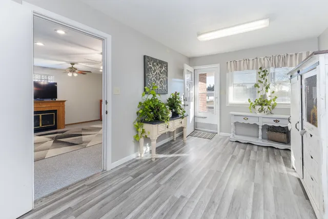a living room with furniture and a kitchen view