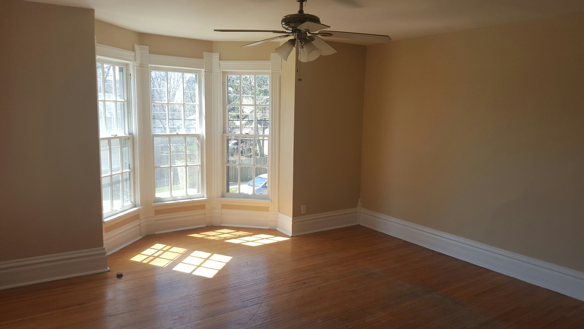486 Ashland Avenue Elgin, IL 60123 - Photo 14 of 21 an empty room with wooden floor and windows