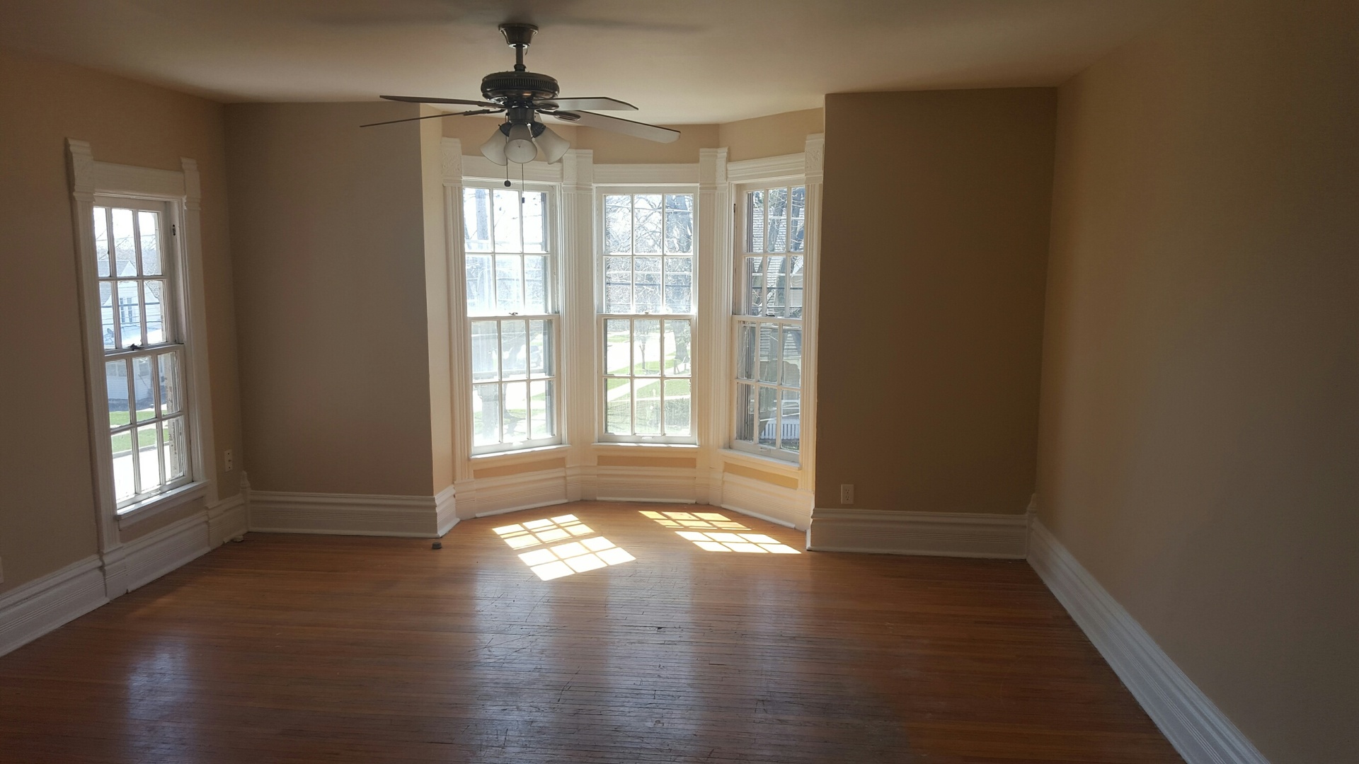 486 Ashland Avenue Elgin, IL 60123 - Photo 15 of 21 a view of empty room with wooden floor and fan