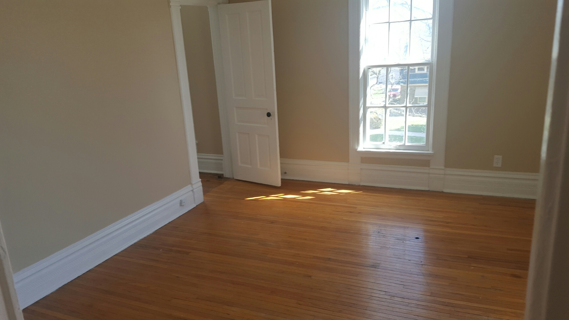 486 Ashland Avenue Elgin, IL 60123 - Photo 16 of 21 an empty room with wooden floor and windows