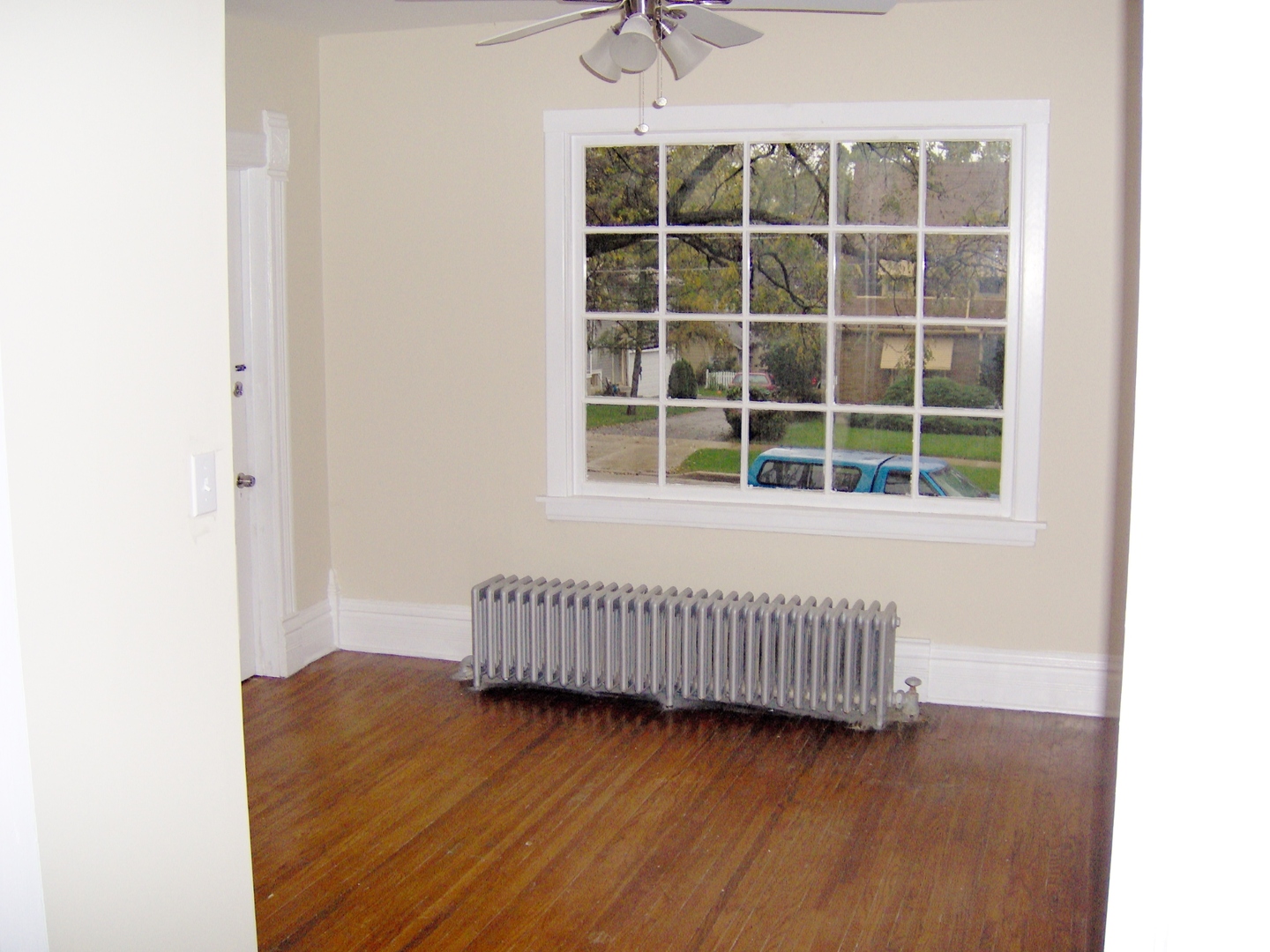 486 Ashland Avenue Elgin, IL 60123 - Photo 7 of 21 a view of a room with wooden floor and windows