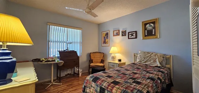 a bedroom with a bed and a chair