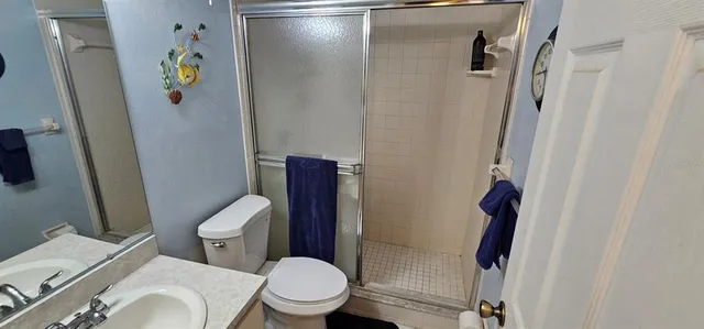 a white toilet sitting next to a bathroom sink