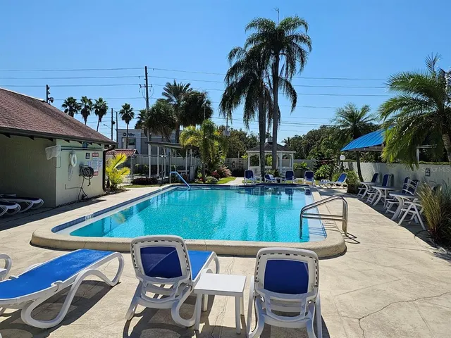 a view of swimming pool with outdoor seating and plants