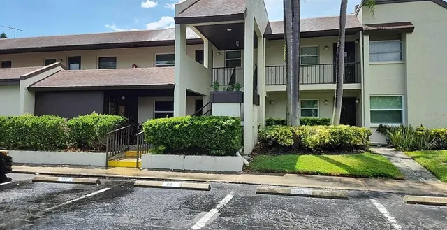 a view of a house with a patio and a yard