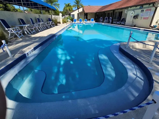 a view of a swimming pool with sitting area