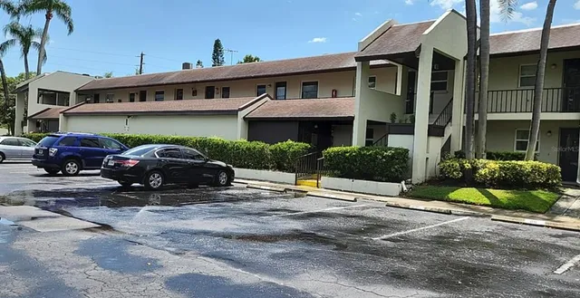 a car parked in front of a white building