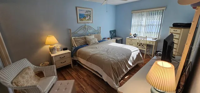 a bed room with a bed and a chair