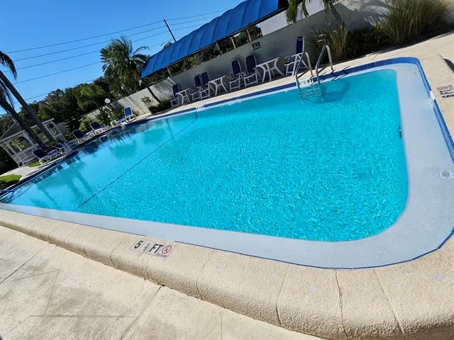 a view of a swimming pools under an umbrella