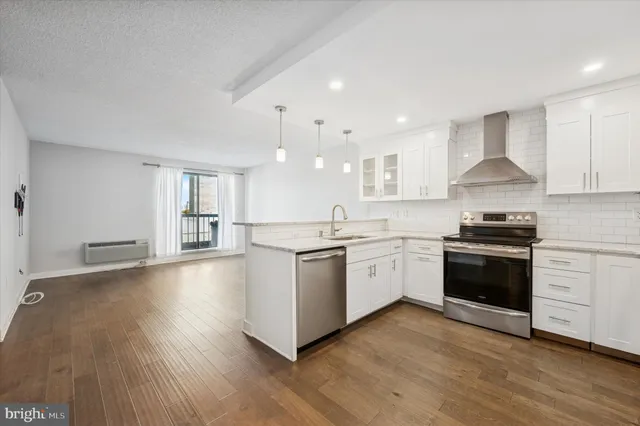 a kitchen with a white stove top oven and cabinets