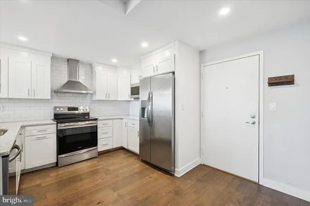 a kitchen with stainless steel appliances granite countertop a refrigerator stove and sink
