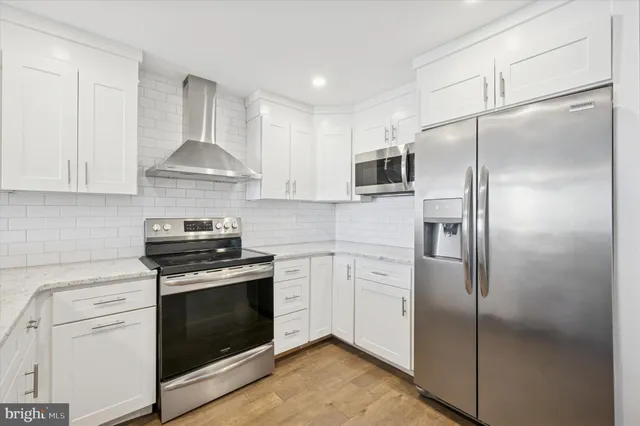 a kitchen with stainless steel appliances a refrigerator stove and microwave