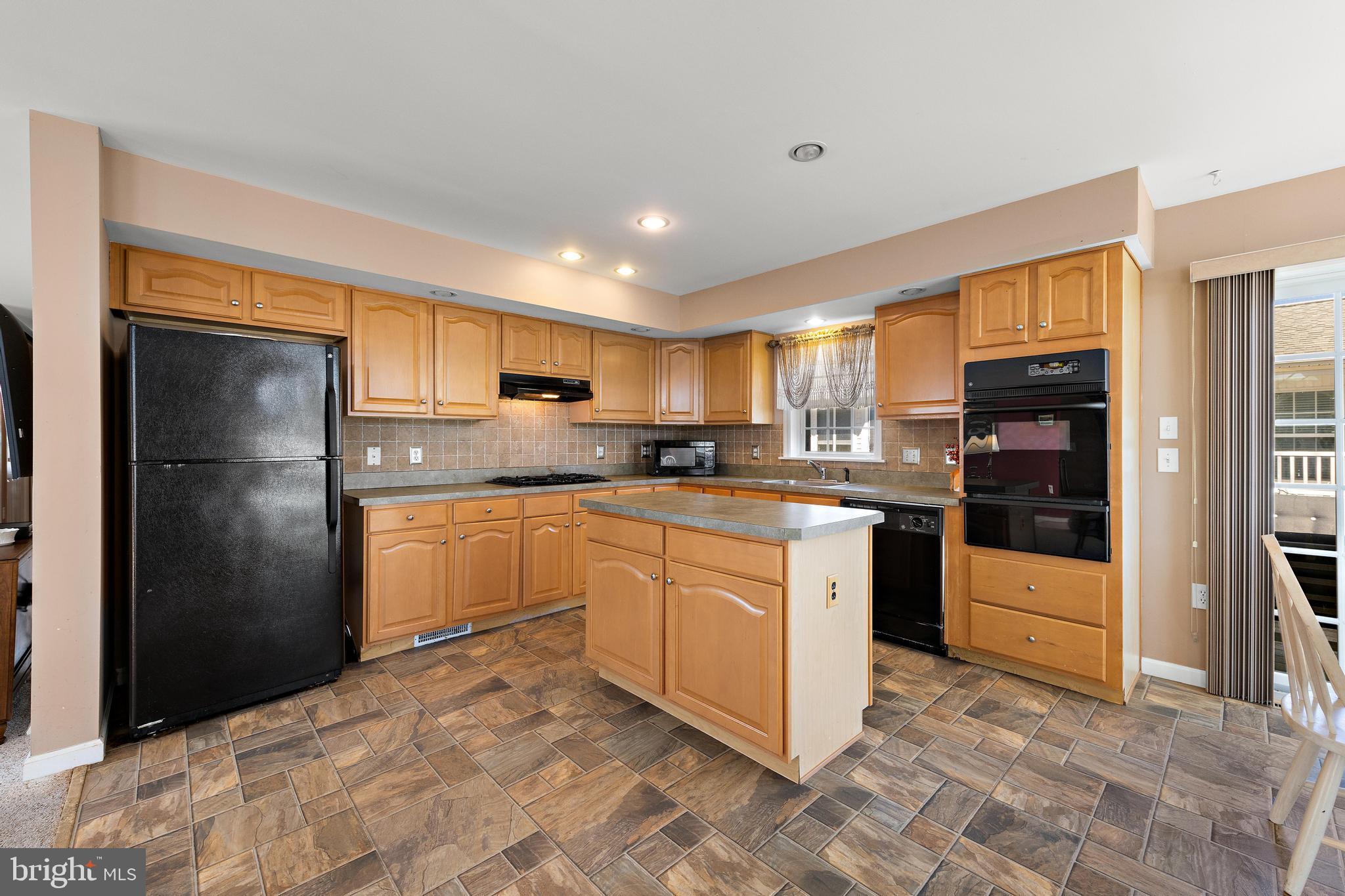 75 Oak Ridge Lane Manahawkin, NJ 08050 - Photo 11 of 50 a kitchen with stainless steel appliances granite countertop a refrigerator and a stove top oven