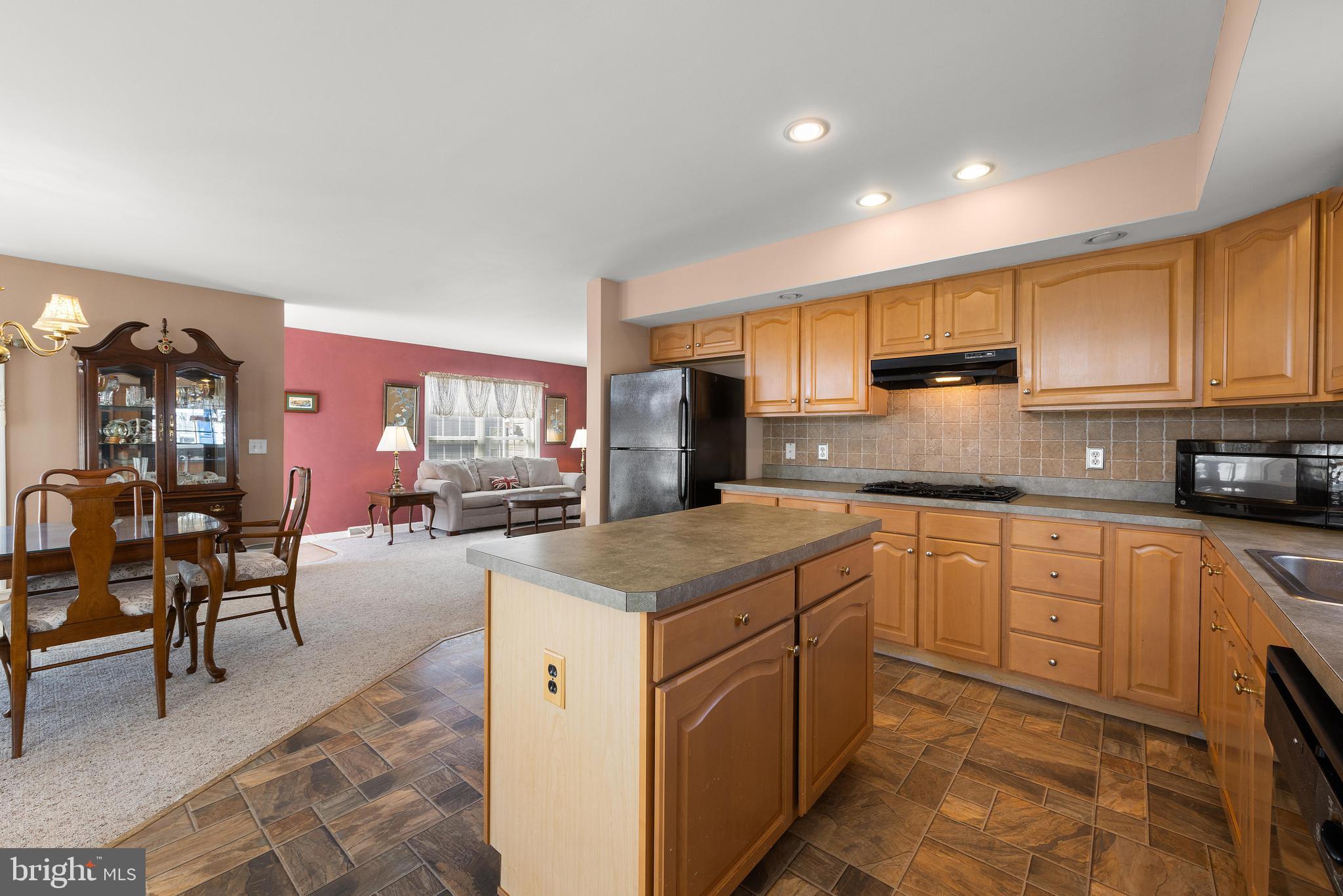 75 Oak Ridge Lane Manahawkin, NJ 08050 - Photo 12 of 50 a kitchen with stainless steel appliances granite countertop wooden cabinets a sink dishwasher a stove and a refrigerator with wooden floor