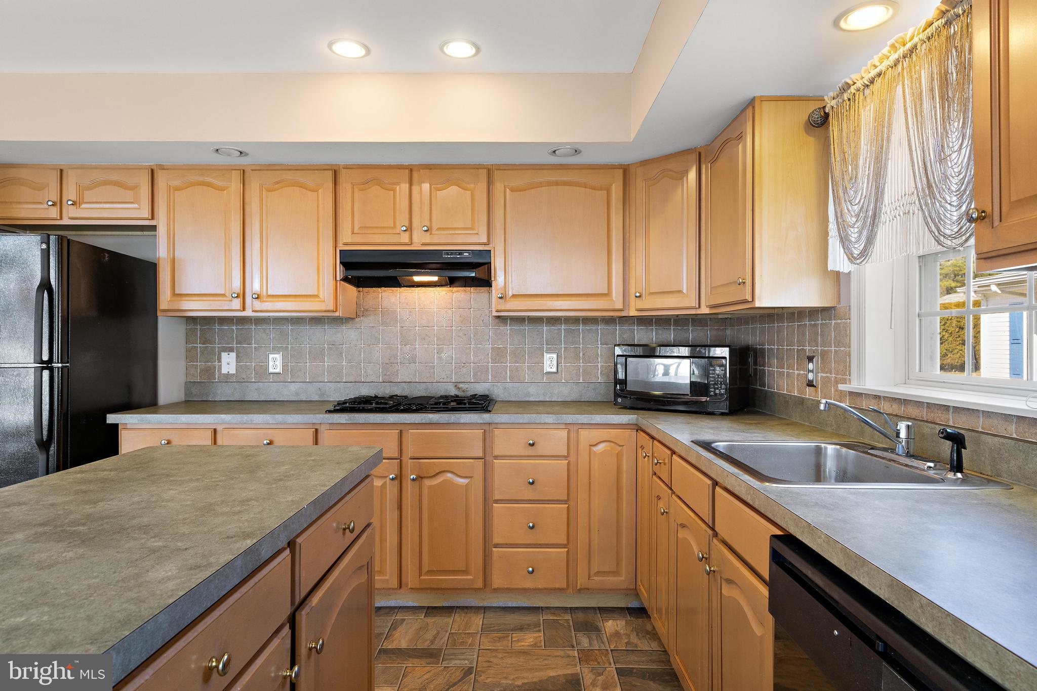 75 Oak Ridge Lane Manahawkin, NJ 08050 - Photo 13 of 50 a kitchen with stainless steel appliances granite countertop a sink a stove and cabinets