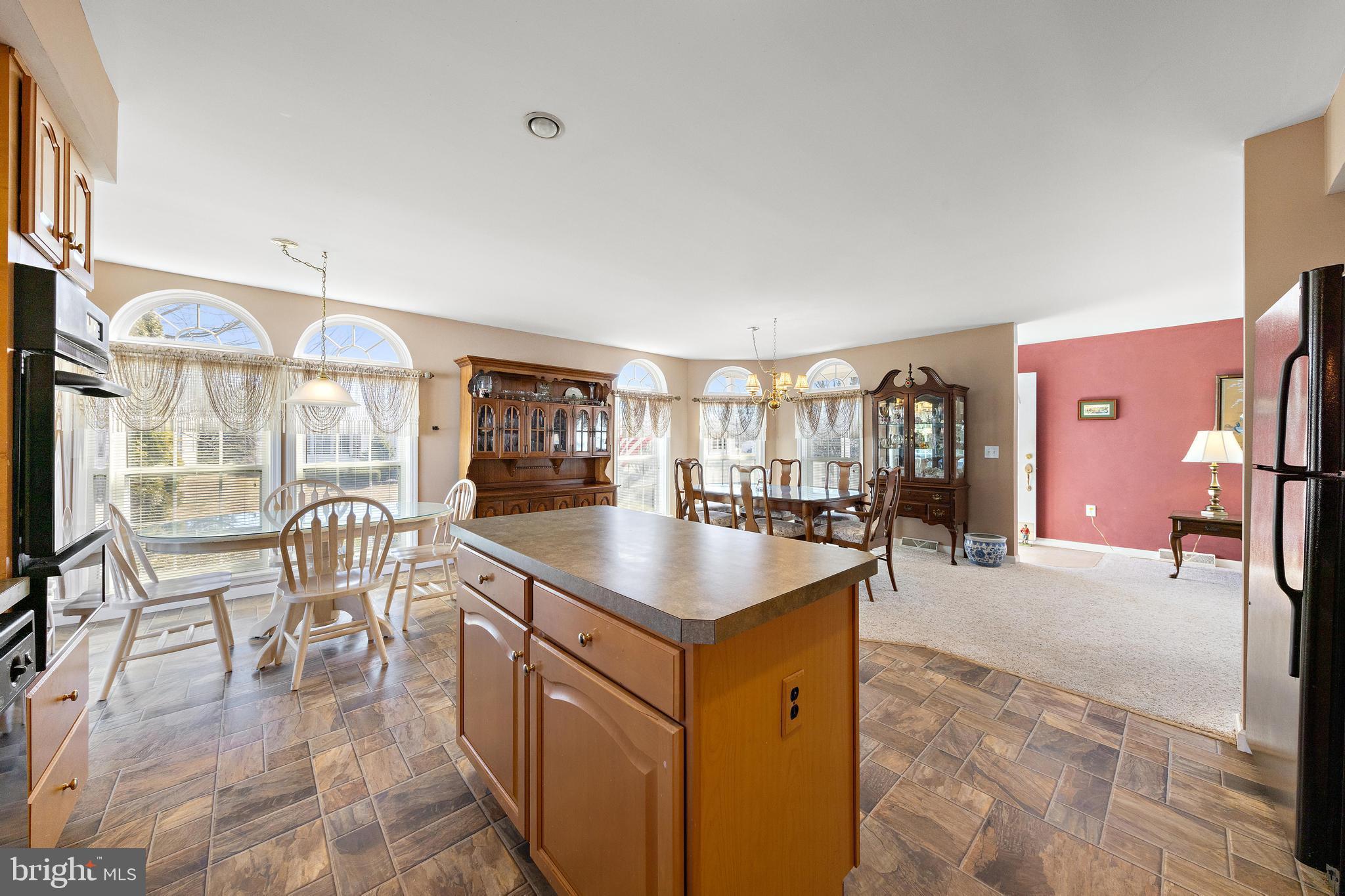 75 Oak Ridge Lane Manahawkin, NJ 08050 - Photo 14 of 50 a kitchen with a table chairs and a view of living room