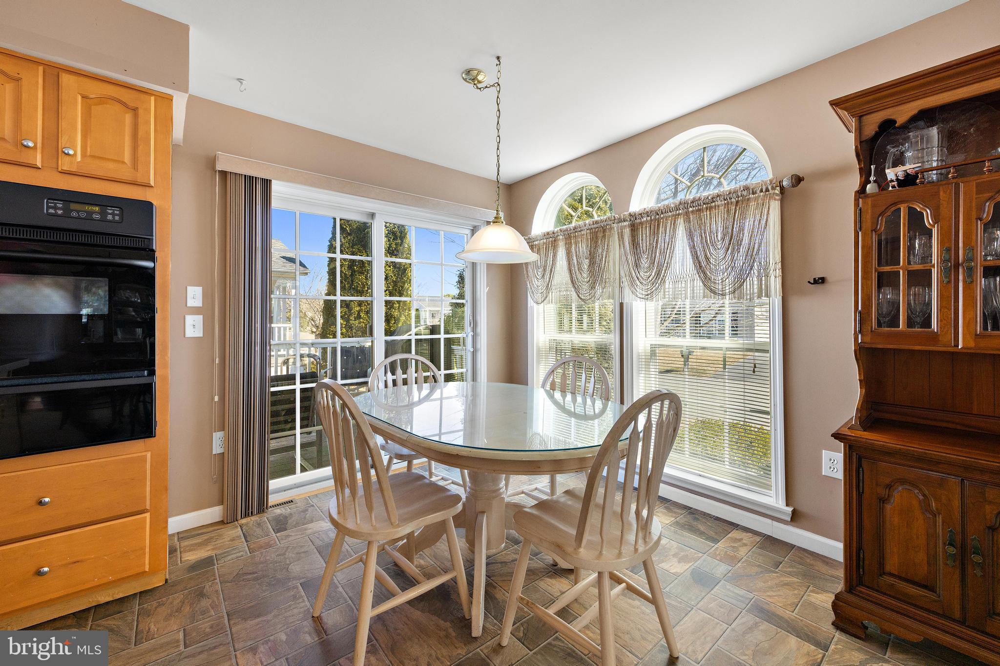 75 Oak Ridge Lane Manahawkin, NJ 08050 - Photo 15 of 50 a dining room with furniture a fireplace and a chandelier
