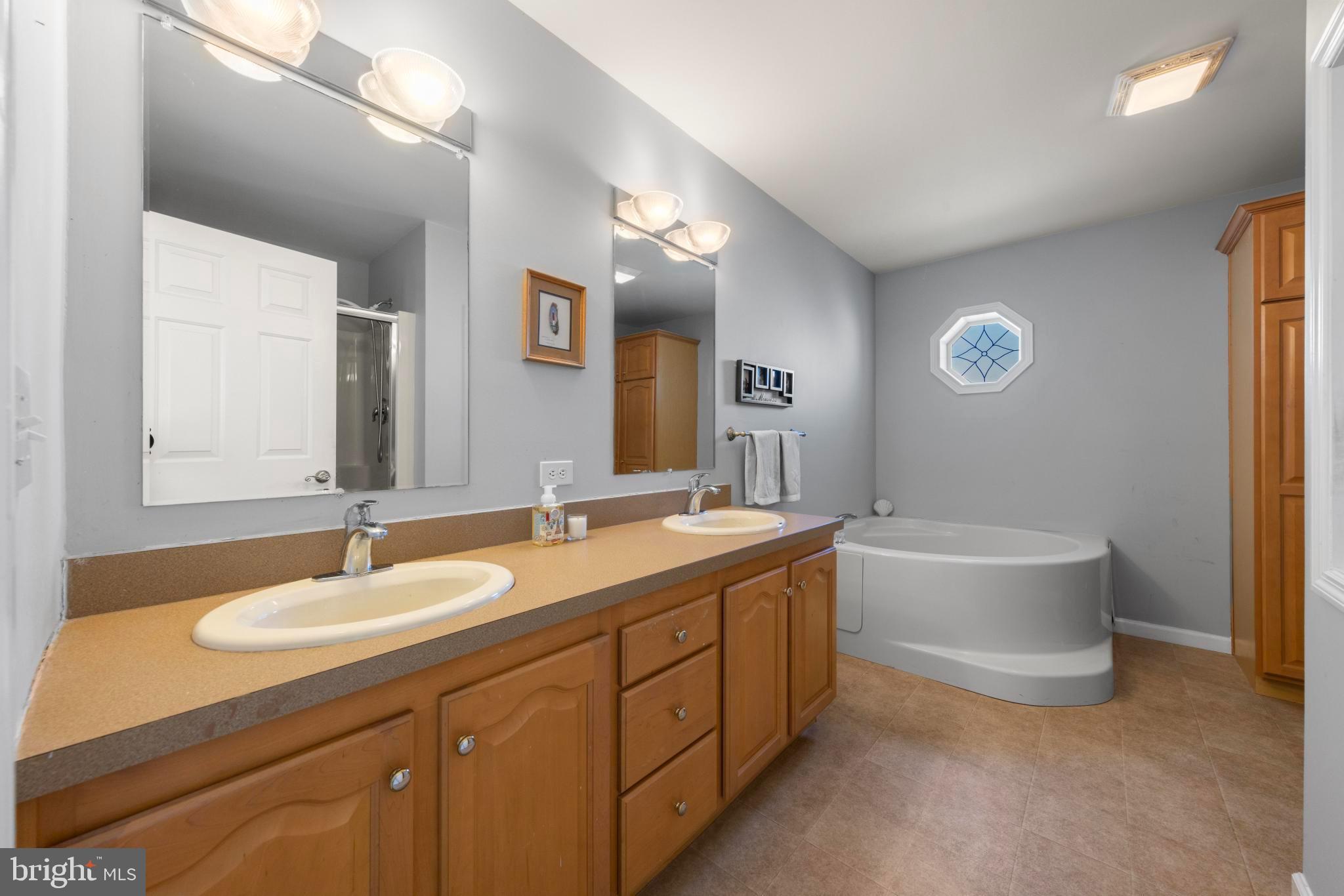 75 Oak Ridge Lane Manahawkin, NJ 08050 - Photo 28 of 50 a spacious bathroom with a granite countertop sink mirror and bathtub
