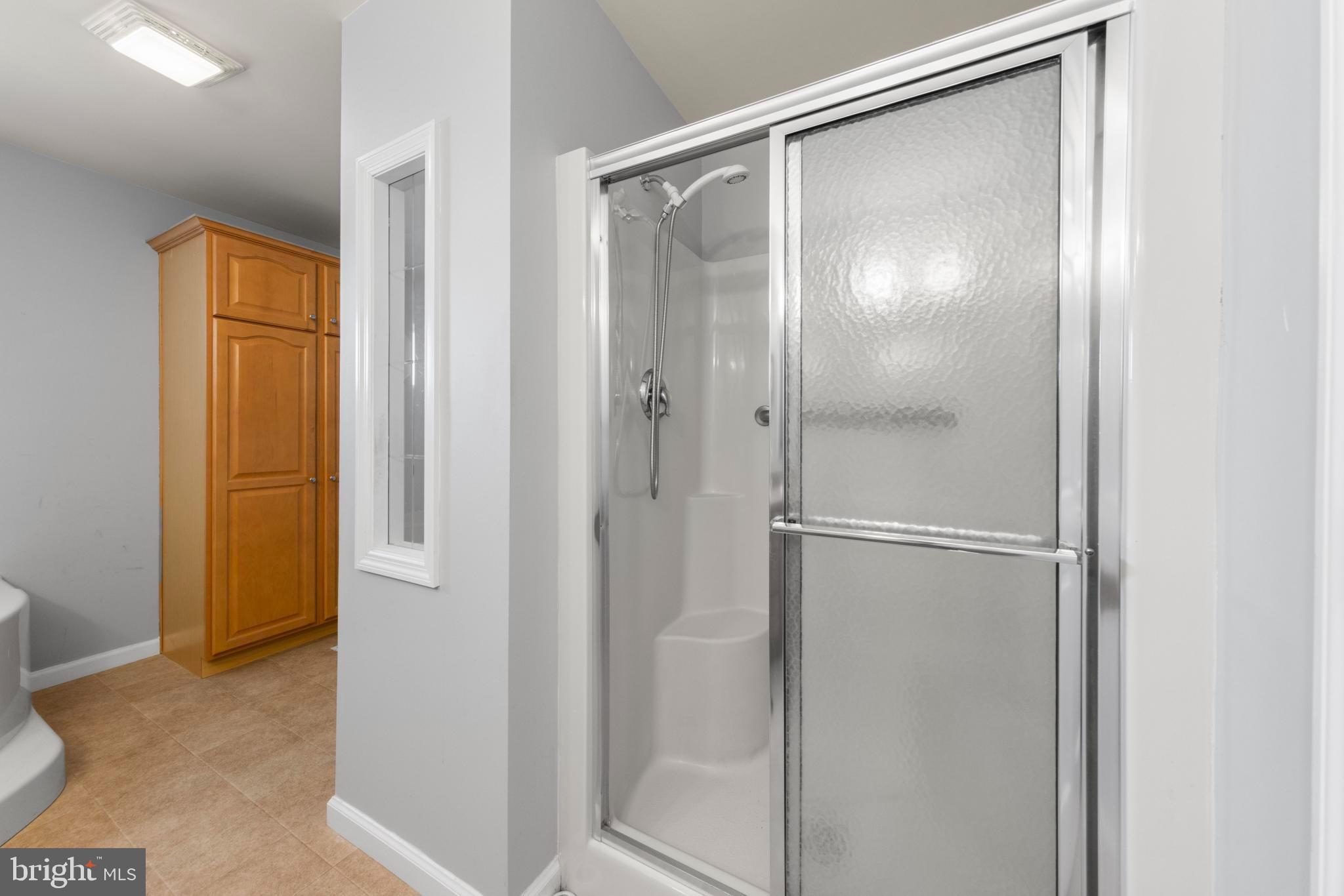 75 Oak Ridge Lane Manahawkin, NJ 08050 - Photo 29 of 50 a bathroom with a glass shower door