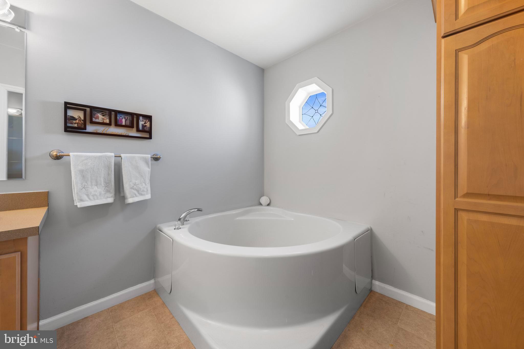75 Oak Ridge Lane Manahawkin, NJ 08050 - Photo 30 of 50 a white bath tub sitting in a bathroom