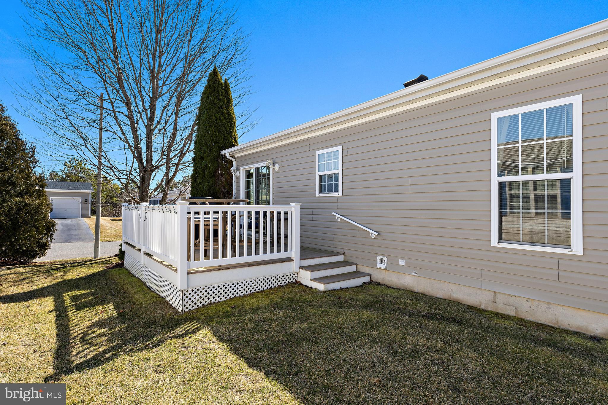 75 Oak Ridge Lane Manahawkin, NJ 08050 - Photo 34 of 50 a view of a house with a small yard and wooden fence