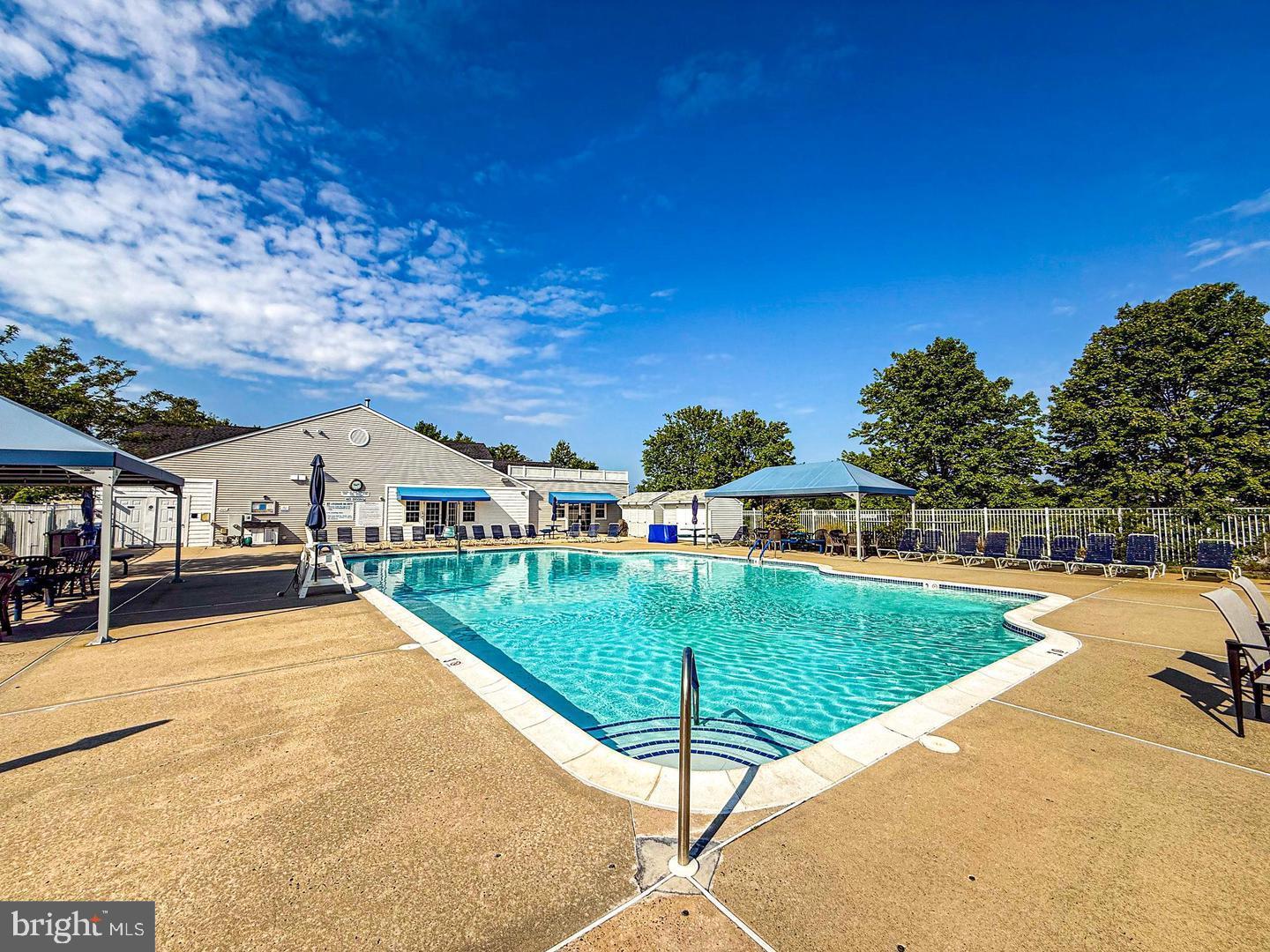 75 Oak Ridge Lane Manahawkin, NJ 08050 - Photo 43 of 50 a view of a swimming pool and trees in the background