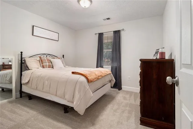 a bedroom with a bed and a mirror